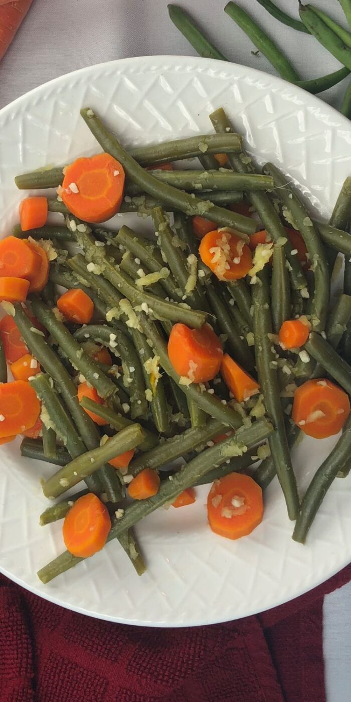 Green beans and carrot sticks saut&eacute;ed with fresh ginger, served hot as a side for lemon chicken.