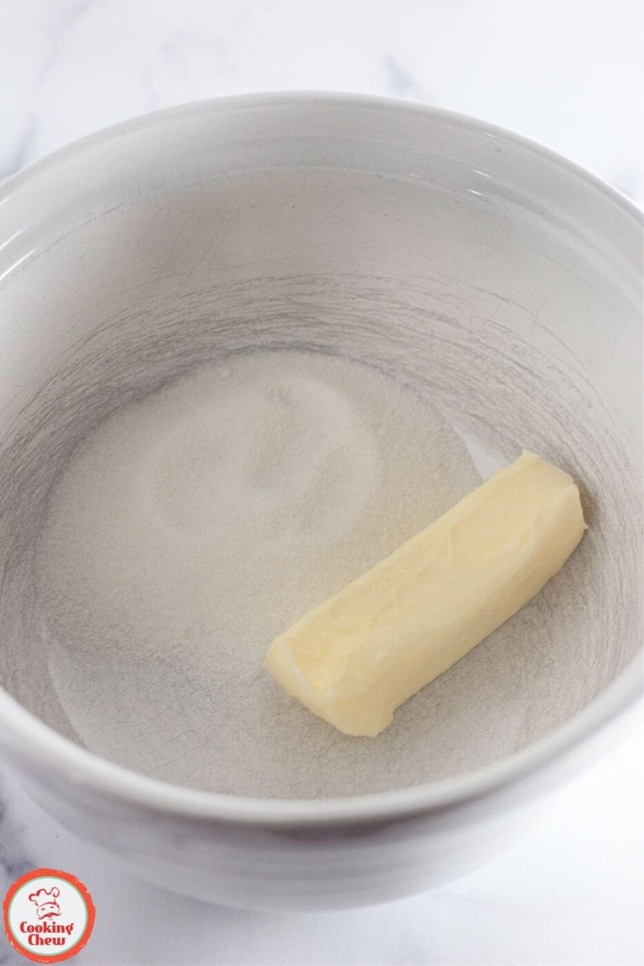 A mixing bowl with cookie dough batter and sprinkles.