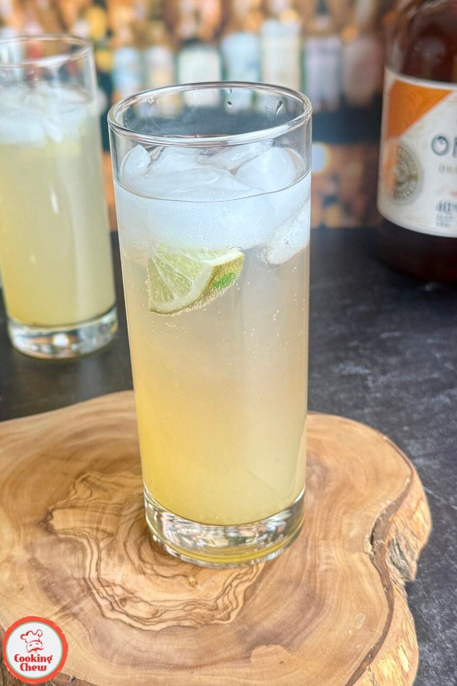 A spicy jalape&ntilde;o lime fizz cocktail served in a glass with fresh lime slices and jalape&ntilde;o rounds.