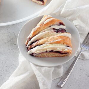 Crescent roll ring with sweet raspberry cream cheese filling and icing drizzle.