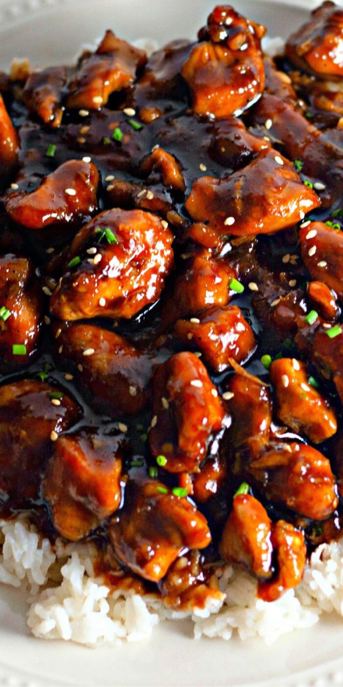 Sticky and sweet bourbon chicken glazed in a rich sauce, served in a bowl as a better-than-takeout meal
