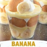 Mini banana pudding cups layered with whipped cream and bananas.