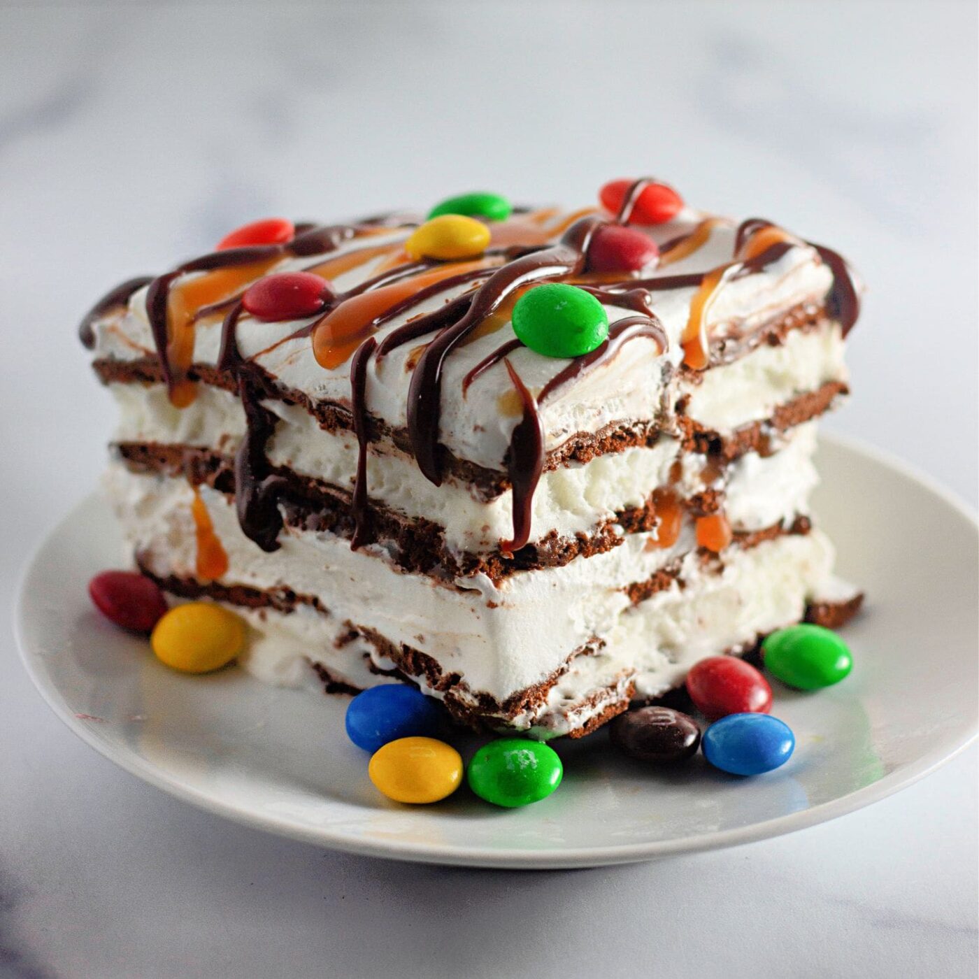 Easy no-bake ice cream cake made with sandwich cookies and fudge.