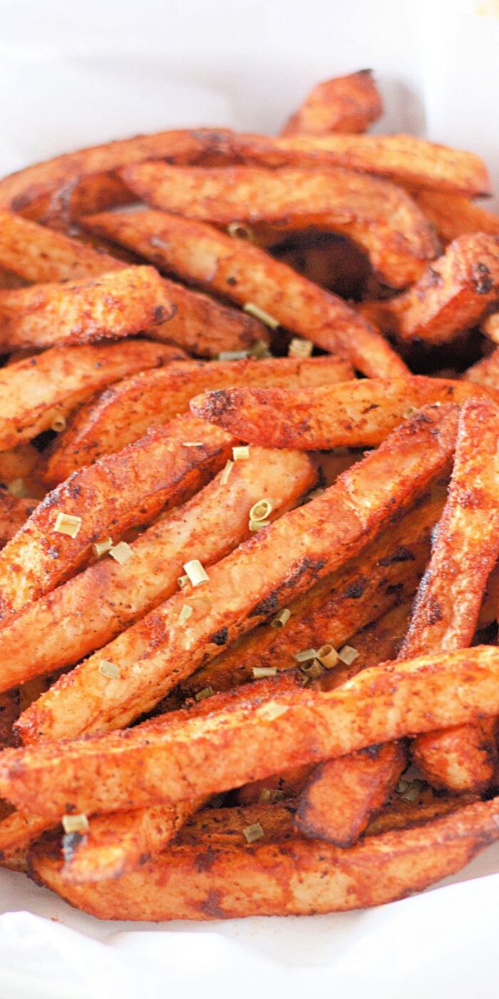 Golden, crispy air fryer seasoned French fries on a plate, served fresh and flavorful, showcasing the golden-brown texture and perfect seasoning.