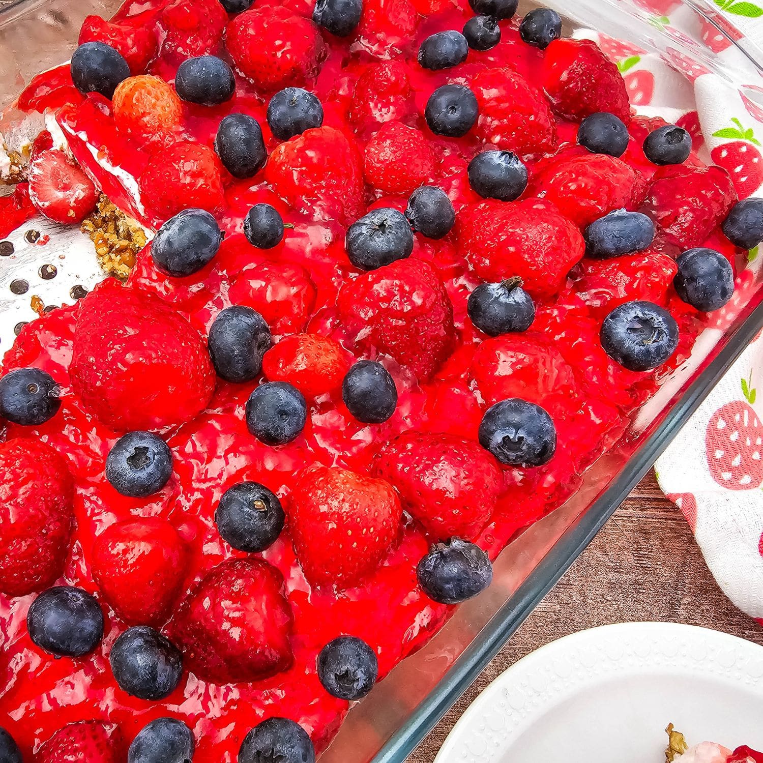 A beautifully styled full view of the Strawberry Blueberry Pretzel Salad.