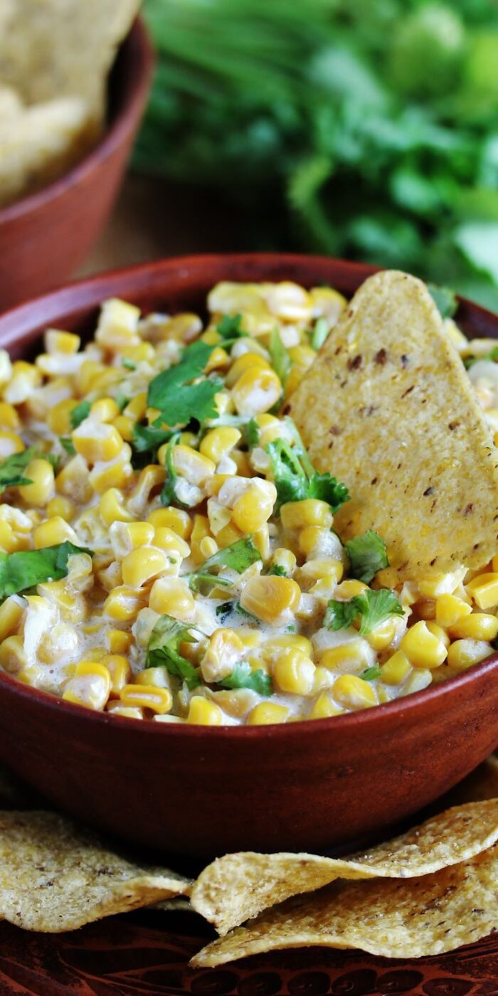 Grilled Mexican street corn topped with creamy mayo, cheese, and spices for the perfect tangy flavor.