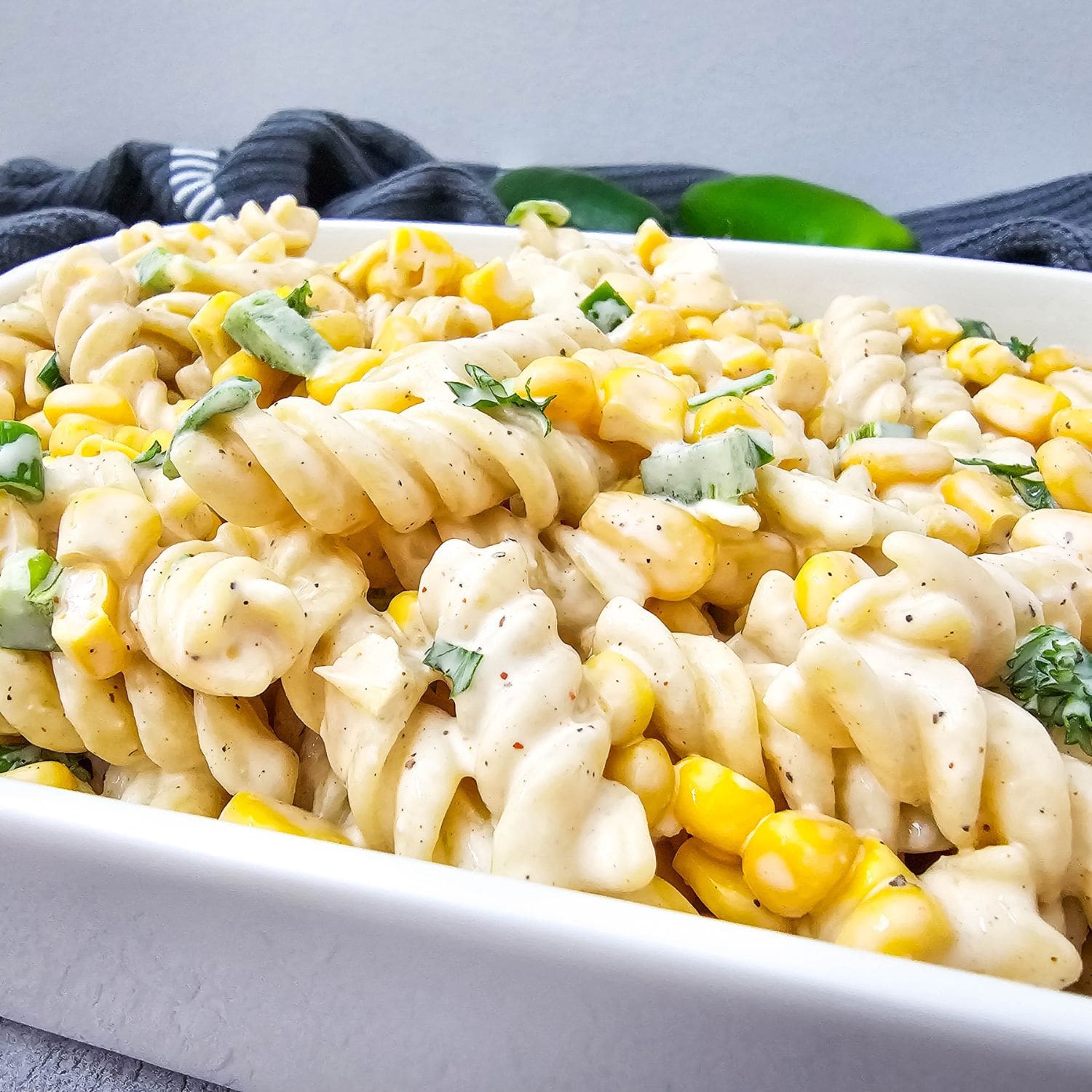 A large, inviting photo of Mexican street corn pasta salad in a serving bowl.