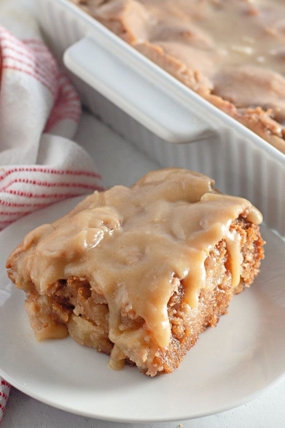 A sliced apple dapple bundt cake on a rustic plate.