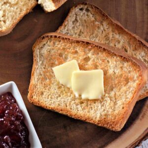 A clear, detailed image of a slice of English muffin bread on a plate, ready to be eaten.