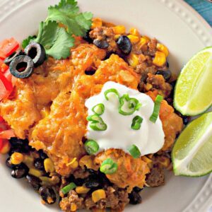 A clear, detailed image of a slice of enchilada tater tot casserole on a plate.