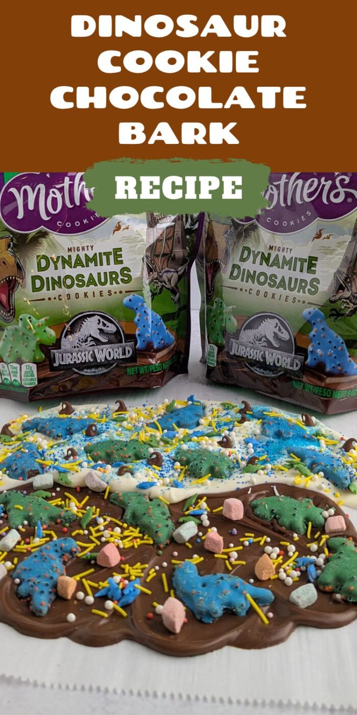 Chocolate and white candy bark topped with dinosaur cookies, marshmallows, and sprinkles.