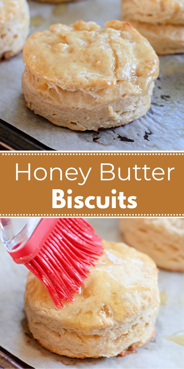 Flaky honey butter biscuits cooling on parchment paper.