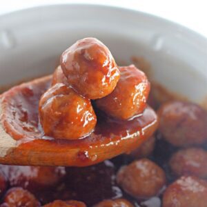 Recipe card image of crockpot honey garlic meatballs in a sweet brown sugar glaze.