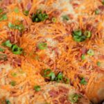 Flaky cheddar biscuits topped with crispy bacon and fresh green onion.