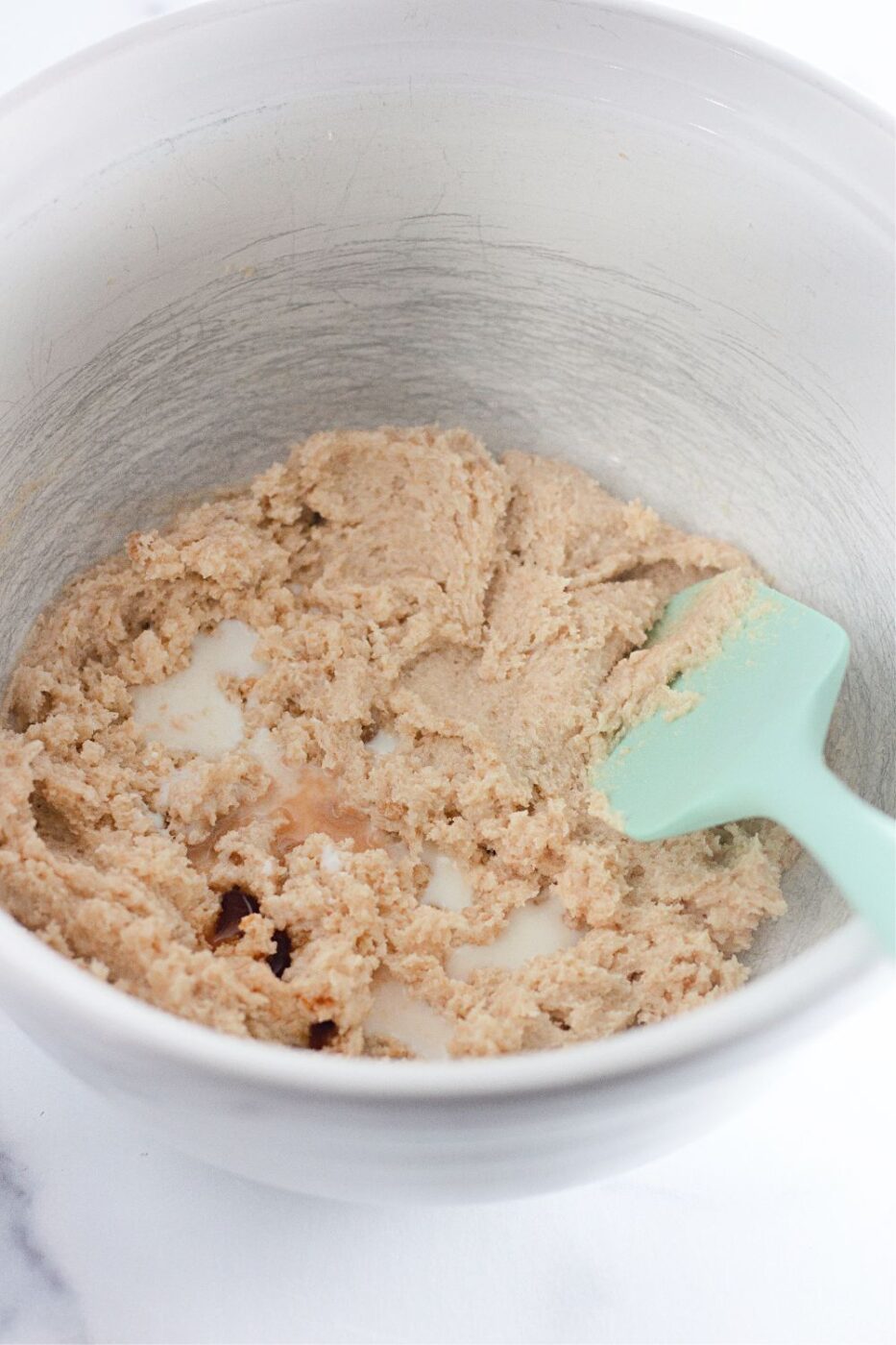 Milk, vanilla, and salt mixed into the creamed butter and sugar.