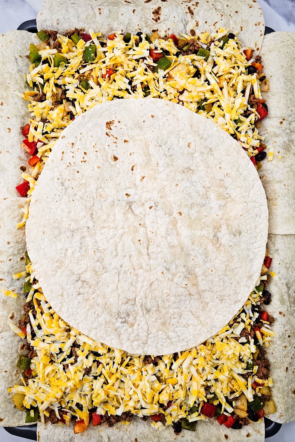 Final tortilla placed in the center over the filling