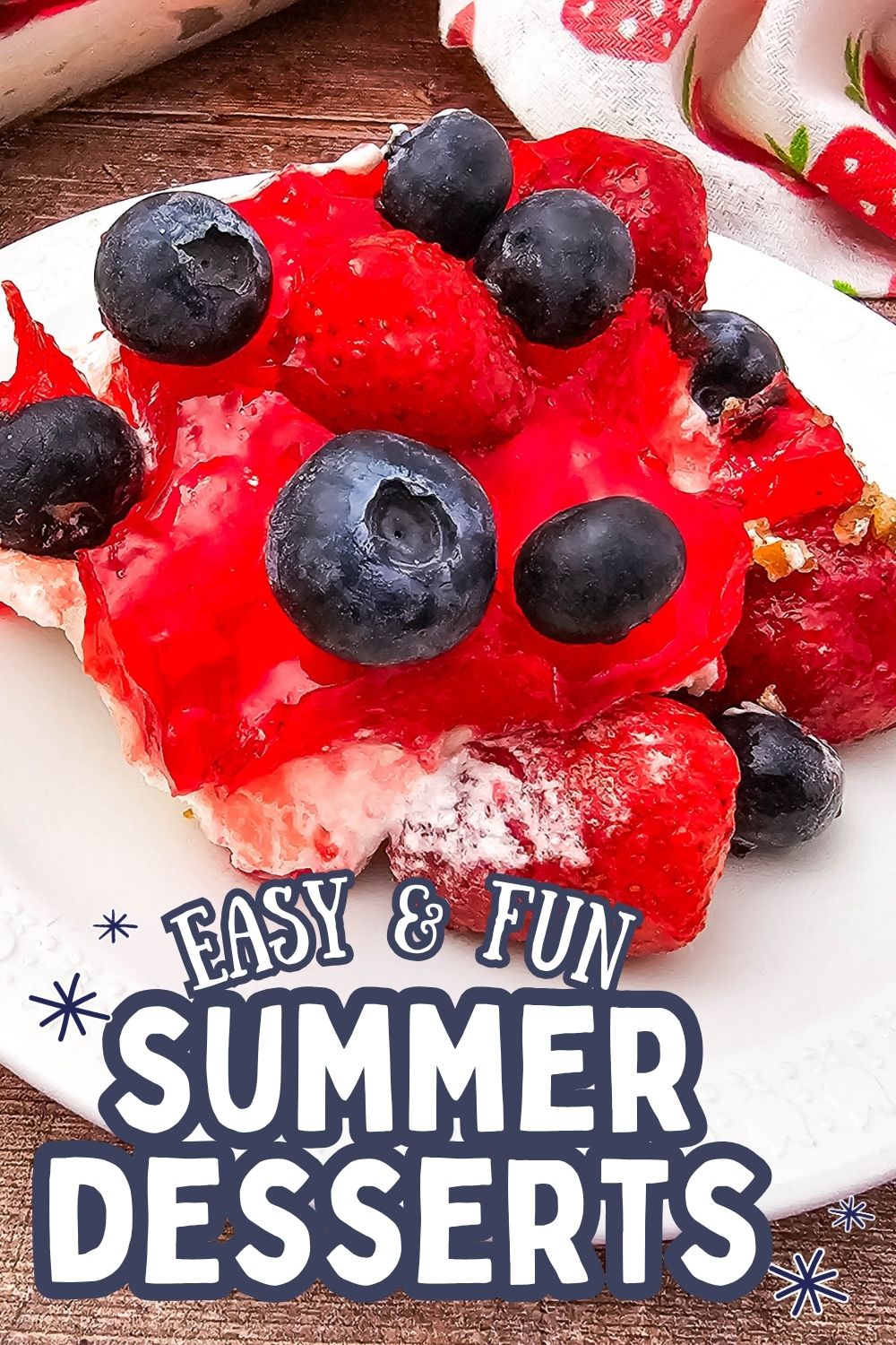 A slice of berry pretzel pie topped with strawberries and blueberries.