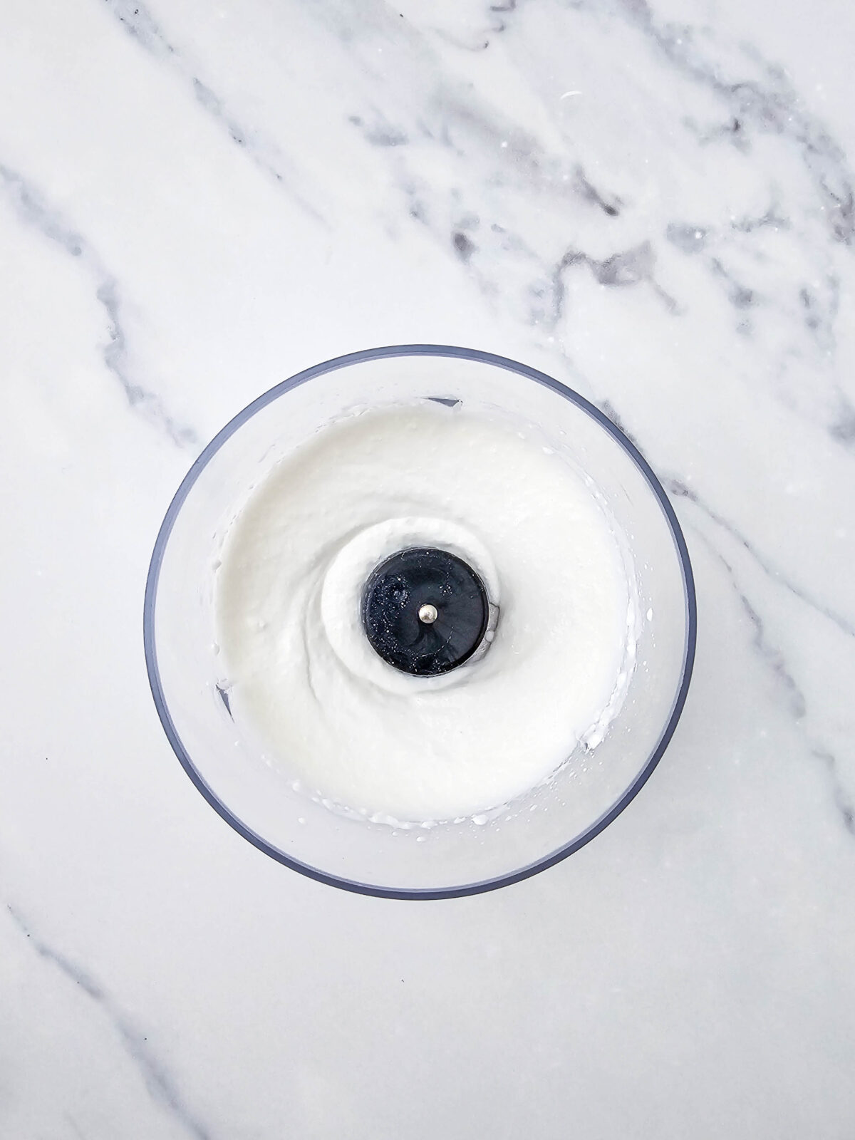 Cottage cheese blended completely smooth in the food processor bowl